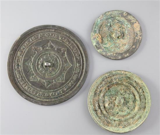 Three Chinese bronze mirrors, Tang dynasty or later, diameter 8.2cm - 13cm